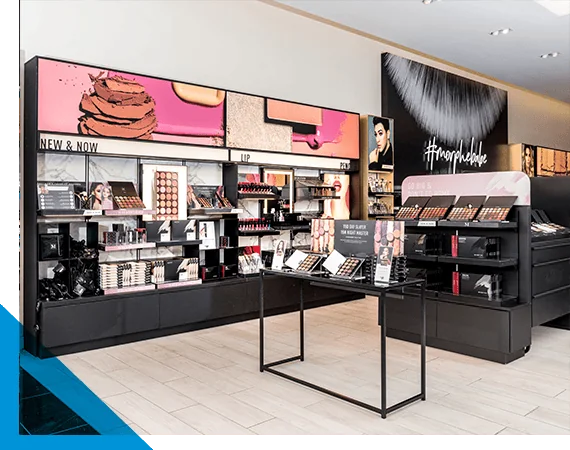 Beauty retail display with fixtures showcasing organized makeup products neatly.