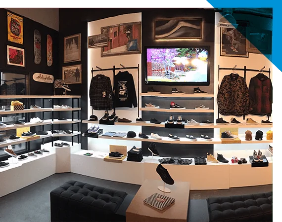 Retail store interior with shelves, racks, clothing displays, and assorted items